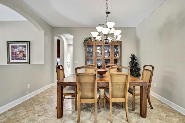 11101 Ragsdale Ct, New Port Richey, FL 34654 - dining room with arched walkways, a chandelier, and light tile patterned floors