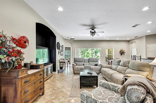 11101 Ragsdale Ct, New Port Richey, FL 34654 - living area featuring a ceiling fan, arched walkways, recessed lighting, a textured ceiling, and light tile patterned floors