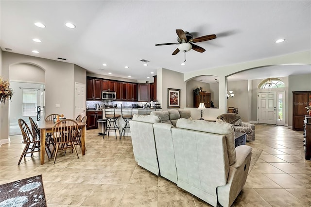 11101 Ragsdale Ct, New Port Richey, FL 34654 - living room featuring light tile patterned flooring, ceiling fan, recessed lighting, plenty of natural light, and arched walkways