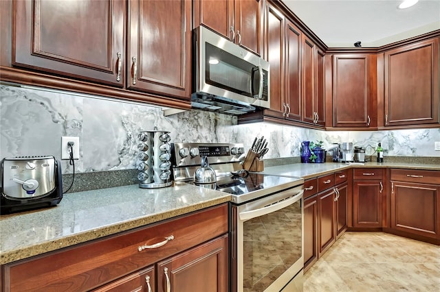 11101 Ragsdale Ct, New Port Richey, FL 34654 - kitchen featuring appliances with stainless steel finishes, light stone counters, tasteful backsplash, and light tile patterned flooring