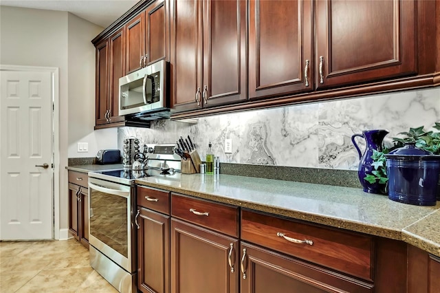 11101 Ragsdale Ct, New Port Richey, FL 34654 - kitchen with stainless steel appliances, backsplash, and light tile patterned floors