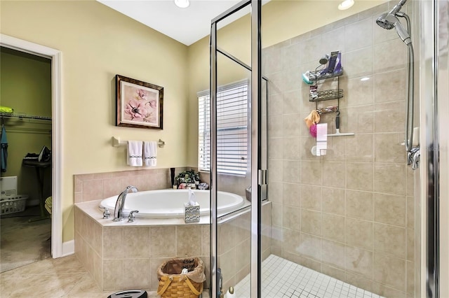 11101 Ragsdale Ct, New Port Richey, FL 34654 - bathroom featuring a garden tub, a stall shower, and tile patterned floors