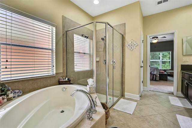 11101 Ragsdale Ct, New Port Richey, FL 34654 - ensuite bathroom featuring a bath, a shower stall, ceiling fan, and tile patterned floors