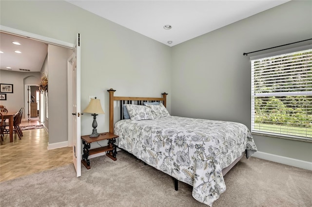 11101 Ragsdale Ct, New Port Richey, FL 34654 - bedroom featuring light colored carpet, recessed lighting, and arched walkways