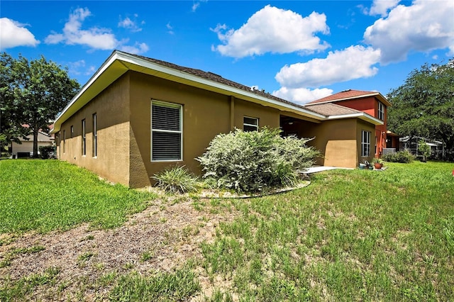 11101 Ragsdale Ct, New Port Richey, FL 34654 - view of side of property with stucco siding and a lawn