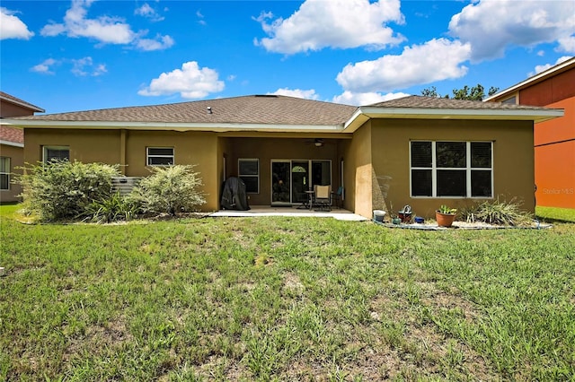11101 Ragsdale Ct, New Port Richey, FL 34654 - rear view of property featuring ceiling fan, stucco siding, a patio, and a lawn