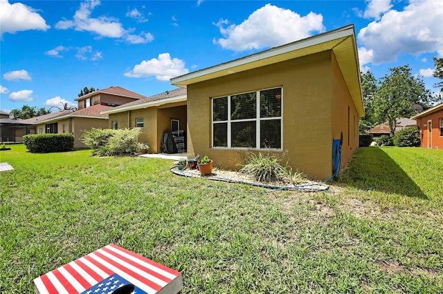 11101 Ragsdale Ct, New Port Richey, FL 34654 - rear view of property with stucco siding and a yard