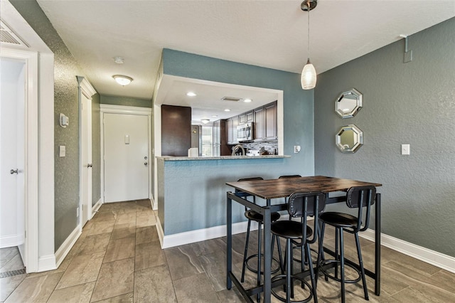 3745 Teeside Dr Unit 3745, New Port Richey, FL 34655 - dining room with a textured wall and baseboards