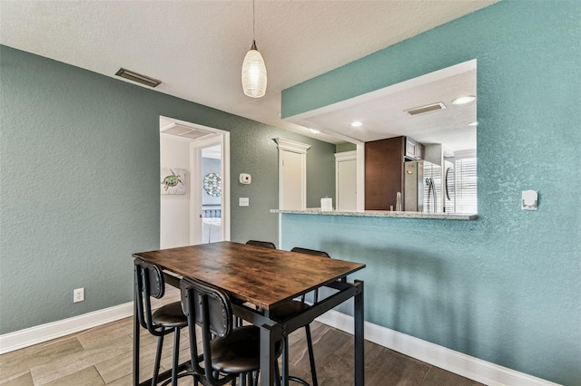 3745 Teeside Dr Unit 3745, New Port Richey, FL 34655 - dining room featuring a textured wall, wood finished floors, and recessed lighting