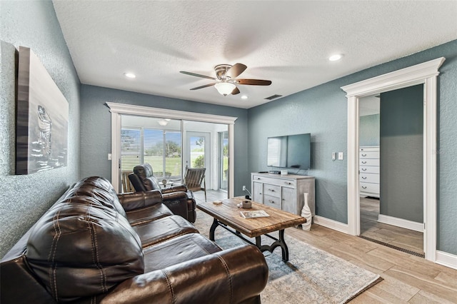 3745 Teeside Dr Unit 3745, New Port Richey, FL 34655 - living room with a ceiling fan, a textured wall, a textured ceiling, and recessed lighting