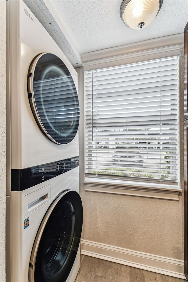 3745 Teeside Dr Unit 3745, New Port Richey, FL 34655 - laundry room with estacked washer and dryer and a textured ceiling