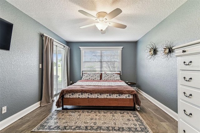 3745 Teeside Dr Unit 3745, New Port Richey, FL 34655 - bedroom with a textured wall, a textured ceiling, dark wood-type flooring, access to outside, and a ceiling fan