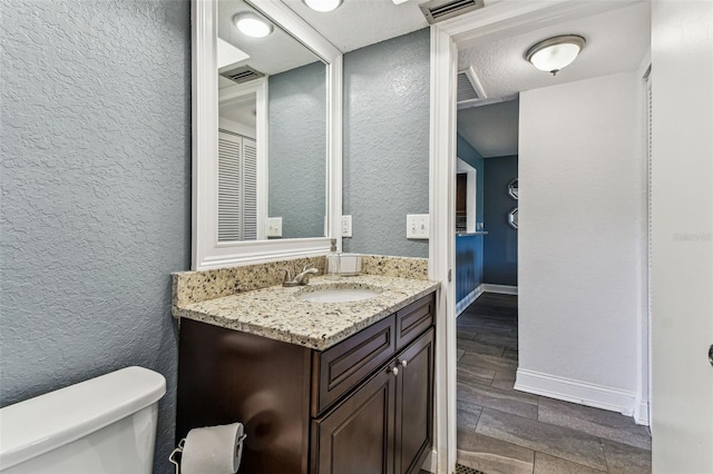 3745 Teeside Dr Unit 3745, New Port Richey, FL 34655 - bathroom featuring vanity, a textured wall, and wood tiled floors