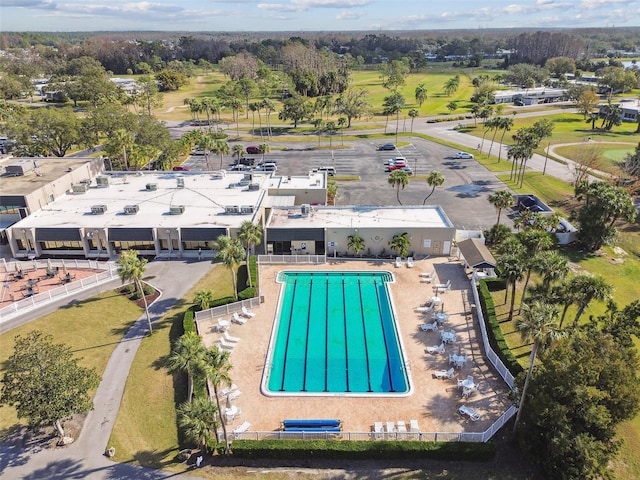 3745 Teeside Dr Unit 3745, New Port Richey, FL 34655 - drone / aerial view of a pool and a tree filled landscape