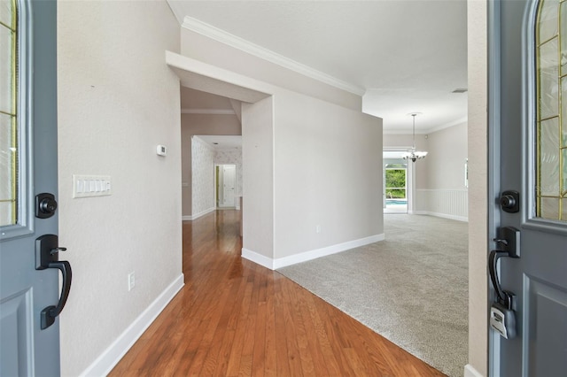 2519 Shipston Ave, New Port Richey, FL 34655 - entrance foyer featuring crown molding, a chandelier, and wood-type flooring