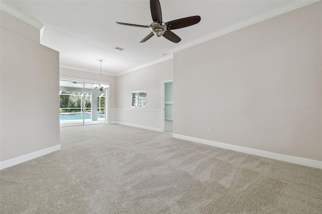 2519 Shipston Ave, New Port Richey, FL 34655 - carpeted empty room featuring crown molding, ceiling fan, and a chandelier