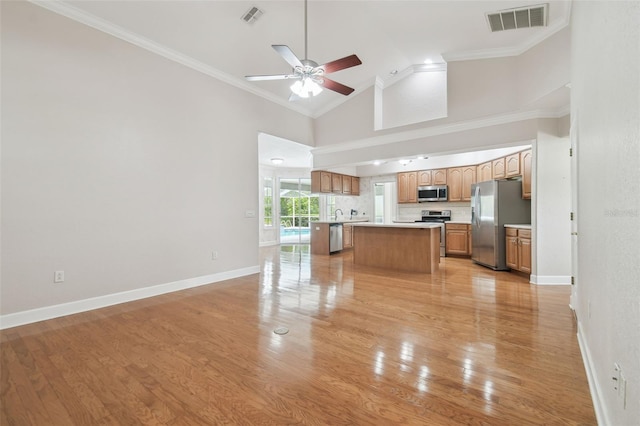 2519 Shipston Ave, New Port Richey, FL 34655 - unfurnished living room featuring ceiling fan, light wood-style flooring, crown molding, and high vaulted ceiling