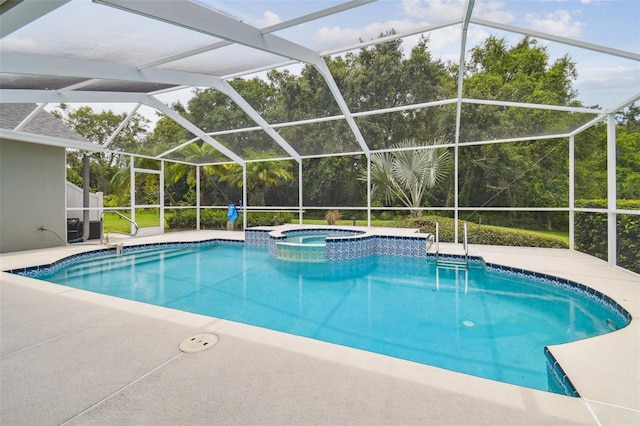 2519 Shipston Ave, New Port Richey, FL 34655 - view of swimming pool featuring a pool with connected hot tub, a lanai, and a patio area