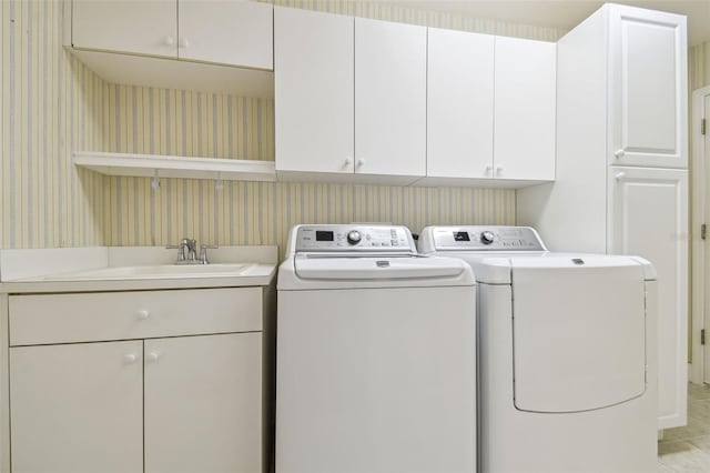 2519 Shipston Ave, New Port Richey, FL 34655 - washroom featuring wallpapered walls, washing machine and clothes dryer, cabinet space, and light tile patterned floors