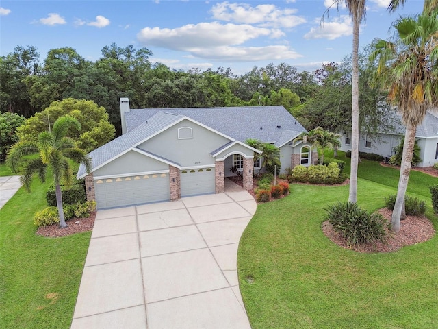 2519 Shipston Ave, New Port Richey, FL 34655 - view of front of property featuring an attached garage, concrete driveway, a front yard, brick siding, and a chimney