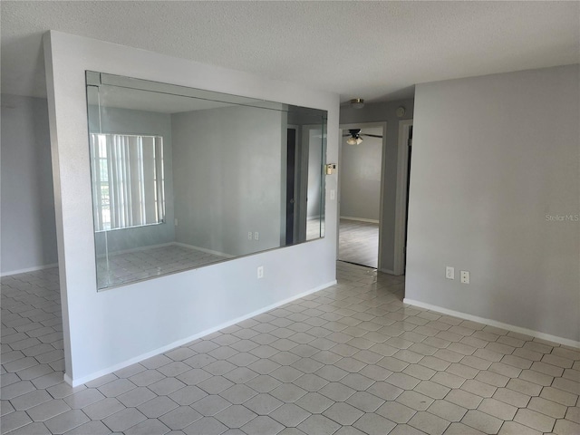 7338 Foxbloom Dr, Port Richey, FL 34668 - spare room featuring a textured ceiling and a ceiling fan