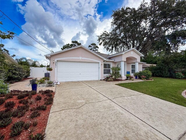 9431 Spring Hill Dr, Spring Hill, FL 34608 - ranch-style house with stucco siding, driveway, and a garage