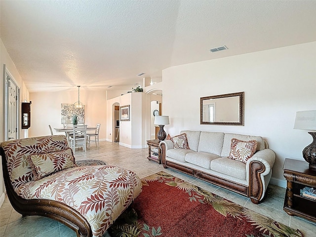 9431 Spring Hill Dr, Spring Hill, FL 34608 - living room with arched walkways, light tile patterned flooring, and a textured ceiling
