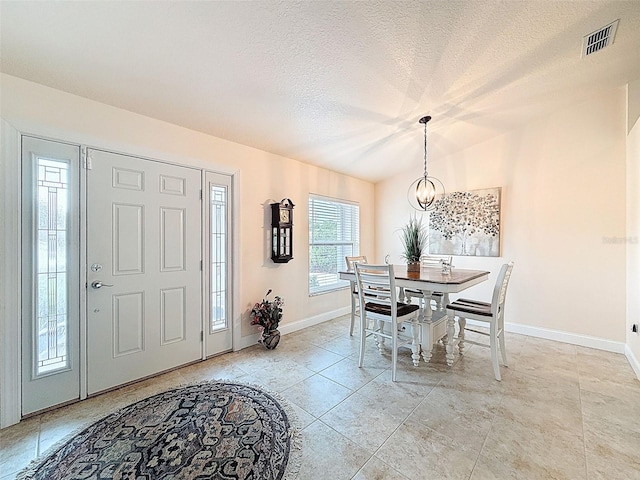 9431 Spring Hill Dr, Spring Hill, FL 34608 - dining room with a chandelier, a textured ceiling, and lofted ceiling