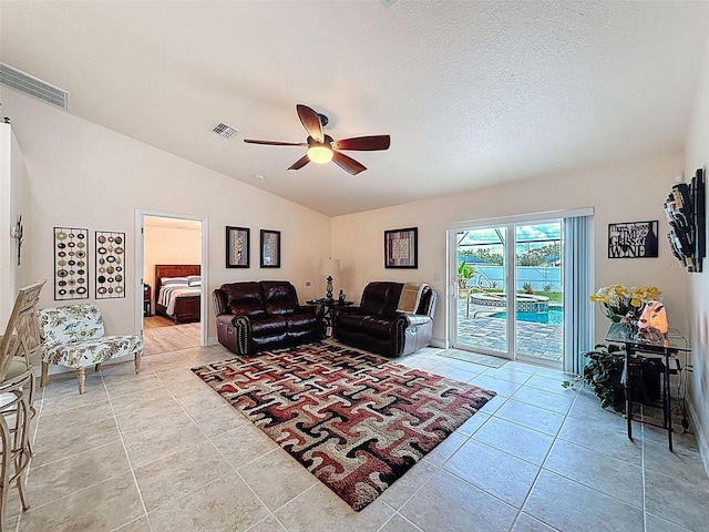 9431 Spring Hill Dr, Spring Hill, FL 34608 - living area with a ceiling fan, vaulted ceiling, and light tile patterned floors