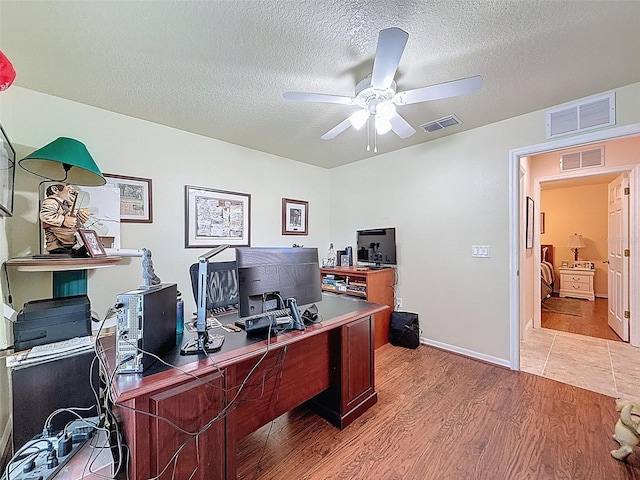 9431 Spring Hill Dr, Spring Hill, FL 34608 - home office with wood finished floors, a textured ceiling, and a ceiling fan