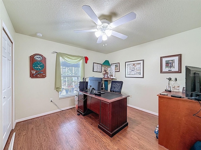 9431 Spring Hill Dr, Spring Hill, FL 34608 - office featuring wood finished floors, a textured ceiling, and a ceiling fan