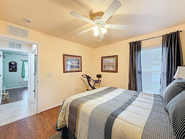 9431 Spring Hill Dr, Spring Hill, FL 34608 - bedroom featuring wood finished floors, a ceiling fan, and a textured ceiling