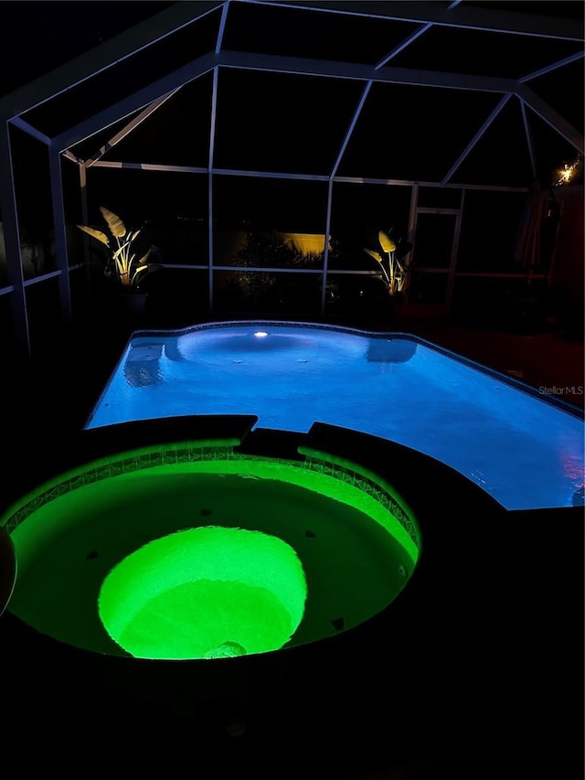 9431 Spring Hill Dr, Spring Hill, FL 34608 - view of pool featuring glass enclosure, a pool with connected hot tub, and a patio
