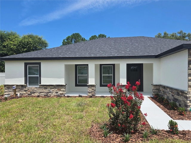 5555 Baffin Cir, Spring Hill, FL 34606 - view of front of house with stone siding, stucco siding, a porch, and roof with shingles