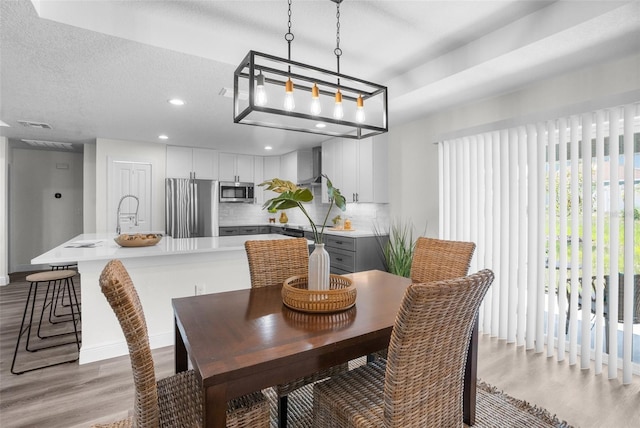 5555 Baffin Cir, Spring Hill, FL 34606 - dining space featuring wood finished floors and recessed lighting