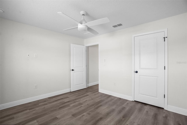 5555 Baffin Cir, Spring Hill, FL 34606 - unfurnished bedroom with wood finished floors and a ceiling fan