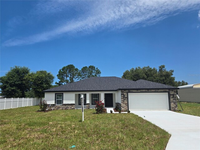 5555 Baffin Cir, Spring Hill, FL 34606 - view of front of home featuring an attached garage, concrete driveway, stone siding, and roof with shingles