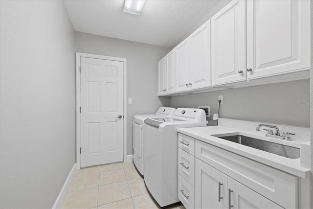 4439 Reeves Rd, New Port Richey, FL 34652 - laundry room with cabinet space, washing machine and dryer, light tile patterned flooring, and a textured ceiling