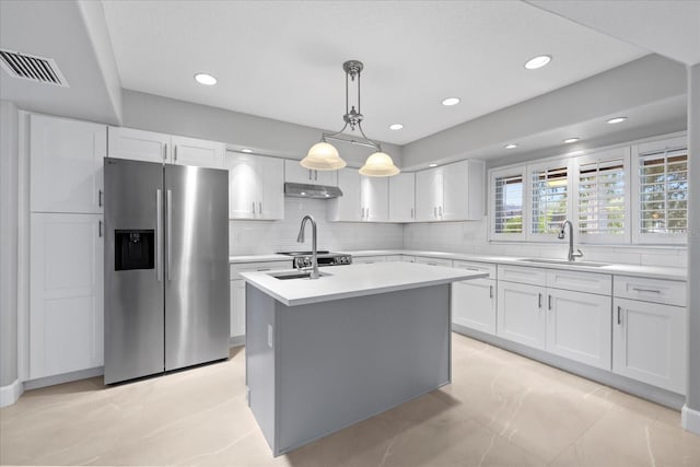 4439 Reeves Rd, New Port Richey, FL 34652 - kitchen featuring stainless steel refrigerator with ice dispenser, light countertops, decorative backsplash, white cabinets, and recessed lighting