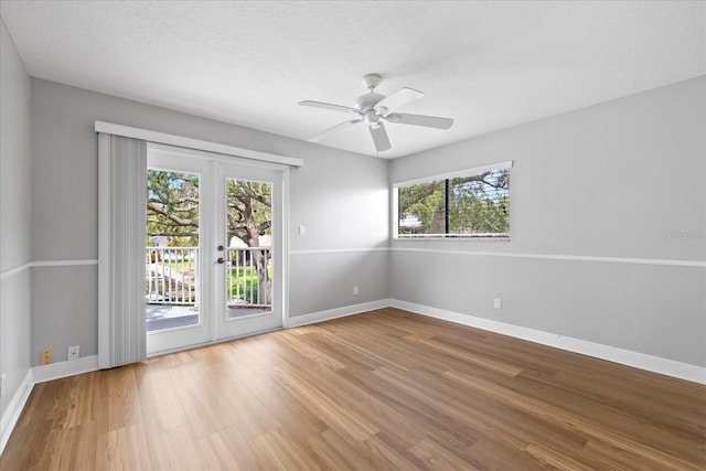 4439 Reeves Rd, New Port Richey, FL 34652 - empty room featuring french doors, wood finished floors, and a ceiling fan