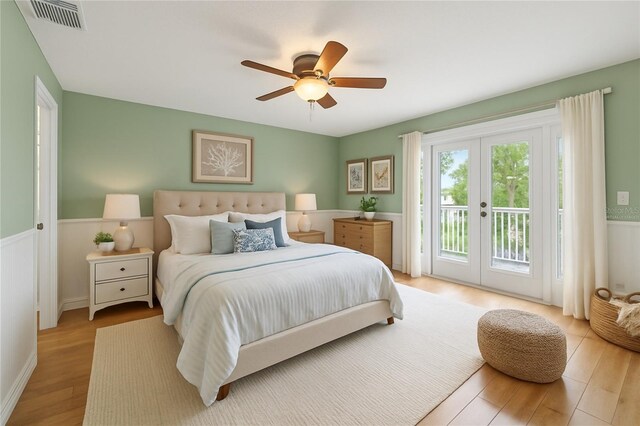 4439 Reeves Rd, New Port Richey, FL 34652 - bedroom with access to outside, french doors, a wainscoted wall, wood finished floors, and ceiling fan