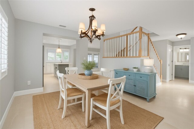 4439 Reeves Rd, New Port Richey, FL 34652 - dining area featuring stairway and a chandelier
