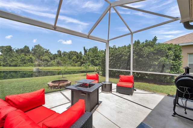 9309 Edistro Pl, New Port Richey, FL 34654 - view of patio / terrace with an outdoor fire pit, a water view, and glass enclosure