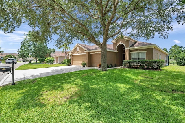 9309 Edistro Pl, New Port Richey, FL 34654 - view of front of house featuring an attached garage, stucco siding, concrete driveway, and a front yard