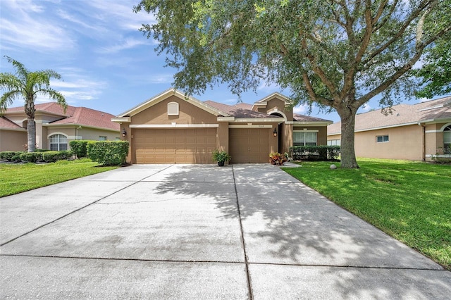 9309 Edistro Pl, New Port Richey, FL 34654 - view of front facade with a garage, stucco siding, a front lawn, and concrete driveway