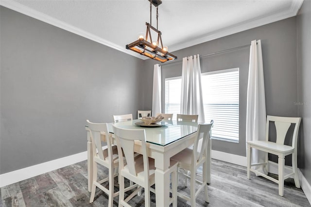 9309 Edistro Pl, New Port Richey, FL 34654 - dining space with a chandelier, ornamental molding, and light wood-style flooring