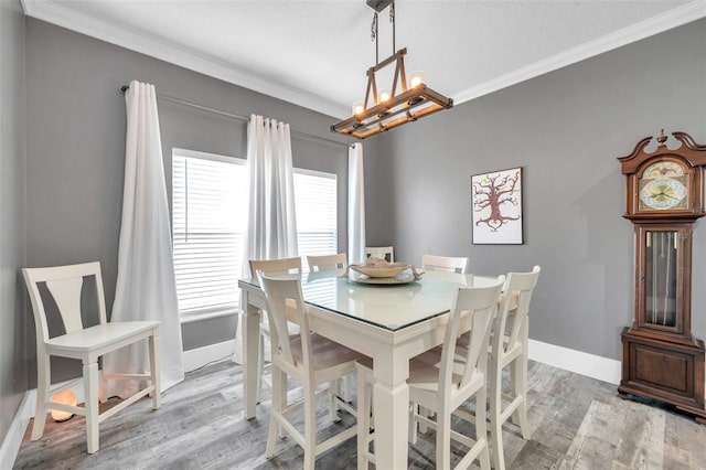 9309 Edistro Pl, New Port Richey, FL 34654 - dining room with a chandelier, crown molding, and light wood-style flooring