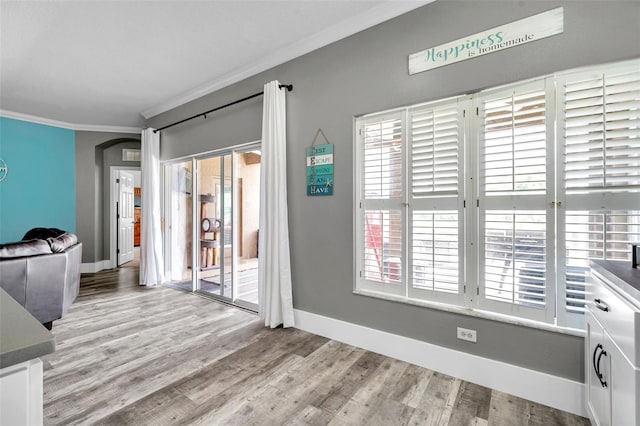 9309 Edistro Pl, New Port Richey, FL 34654 - interior space featuring crown molding, wood finished floors, and arched walkways