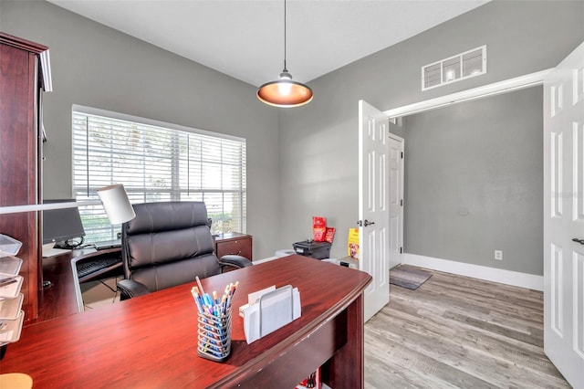 9309 Edistro Pl, New Port Richey, FL 34654 - home office with plenty of natural light and wood finished floors