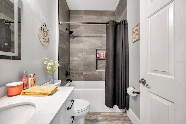 9309 Edistro Pl, New Port Richey, FL 34654 - full bathroom with vanity, shower / bath combination with curtain, wood finished floors, and a textured ceiling